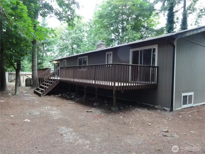Rear of the deck and slider goes to primary bedroom. Rear of the deck and slider goes to primary bedroom.