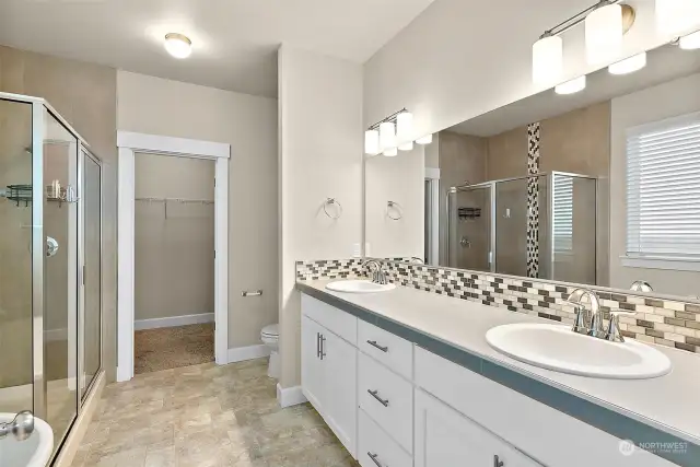 Two sinks because no one likes to share, am I right? Large countertop and cabinet space, beautiful walk-in shower, and large walk in closet