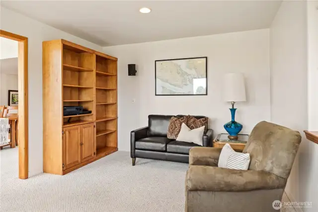 Located just off the living room, your den/office has this great built-in library or media shelf.
