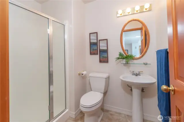 The 3/4 bath is located at the end of the hall, next to the utility room.