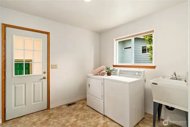 Enter the utility room under the breezeway off the garage. The utility room also offers tons of storage cabinets!