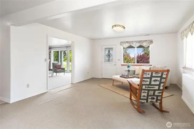 You can access the concrete patio and the bonus room, separated by French doors, with double sliding doors to the patio.