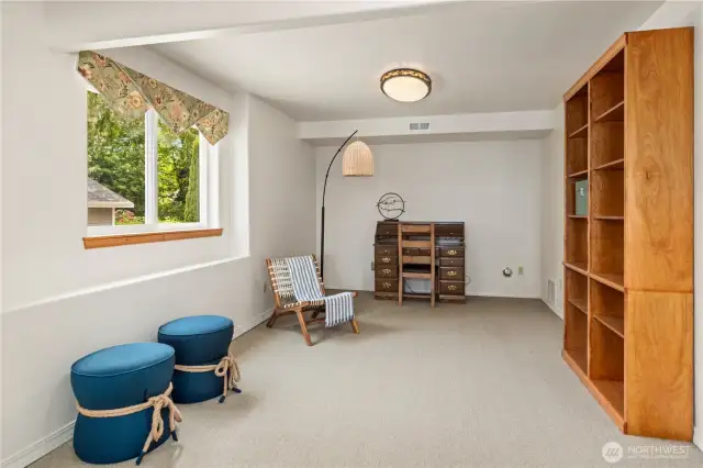 With this lovely built-in bookcase, this area on the lower level might inspire an office or media room.