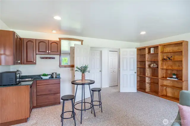 Built-in bookcase and bar with beverage refrigerator located in the large bonus room on the lower level. Note the double-doorway which ltakes you to the 2 bedrooms and full bath.