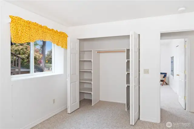 Bedroom #2 closet with built-in shelves.