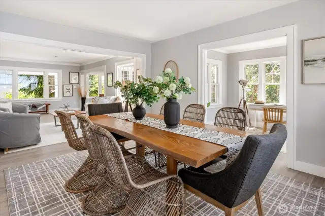 Easily accommodates a 10–12 person dining table, formal sitting area, and side buffets for entertaining at scale