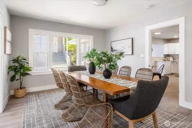 Easily accommodates a 10–12 person dining table, formal sitting area, and side buffets for entertaining at scale
