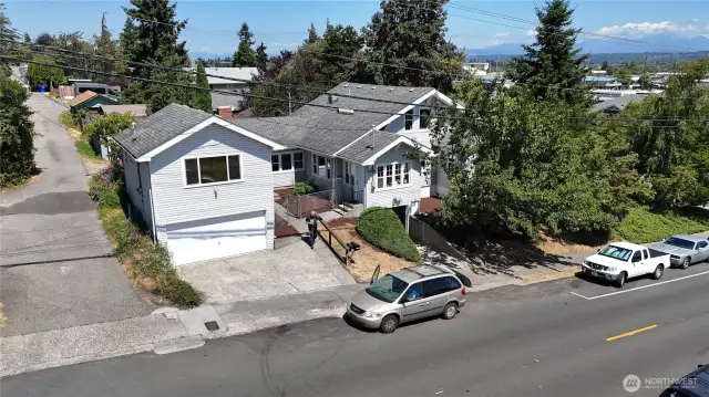 Corner-lot accessory home offers dual access from both the main and side streets, opening onto a private courtyard