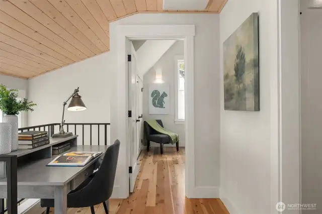 Upstairs two large bedrooms enjoy vaulted ceiling spaces enveloped with warm pine ceilings.