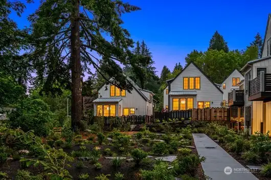 A richly landscaped interior courtyard is planted with flowering and fragrant plantings. The dining room and rear fenced yard overlooks this lush landscape.