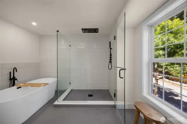 Stunningly redesigned bath offer: rainfall shower, encased shower, soaking tub, and space