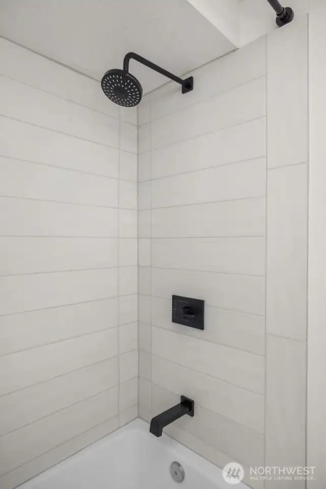 Fully tiled main bath flows with the spare no expense motto into the home.