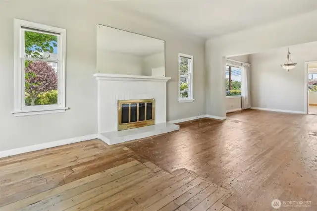 Wood burning fireplace is central to the living room area.