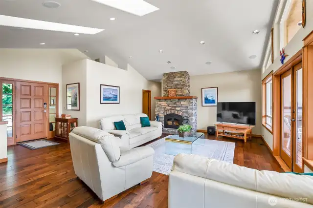 Living room with a tranquil lake view and vaulted ceilings