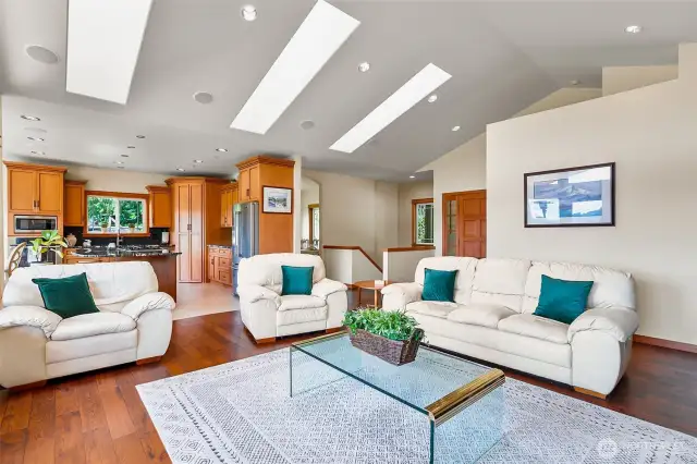 Living room with a tranquil lake view and vaulted ceilings