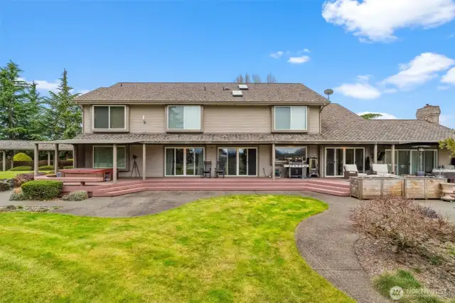 Expansive back deck with multiple slider access points and entertaining areas.
