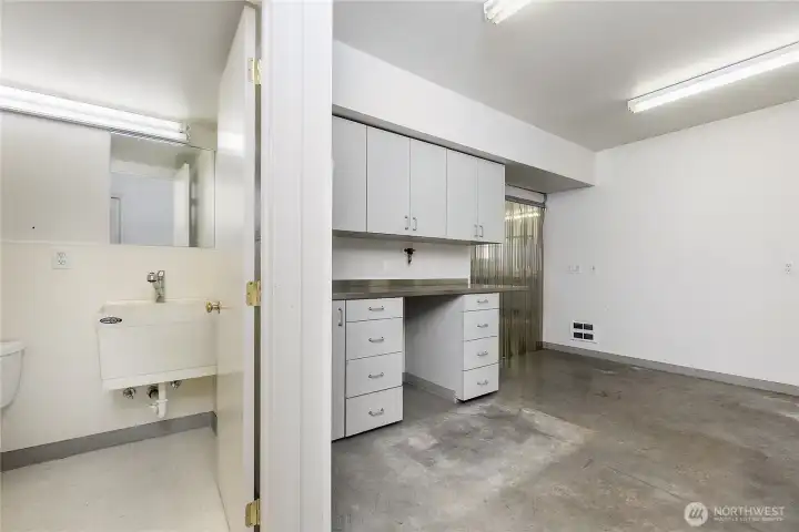 half bath and workshop space in mechanics garage