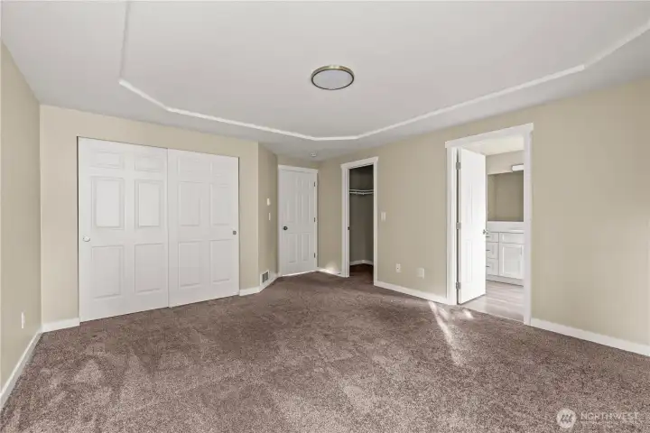 Comfortable primary suite offering two closets, new carpet throughout, and direct access to the updated ensuite bath. Designed for privacy, comfort, and everyday convenience.