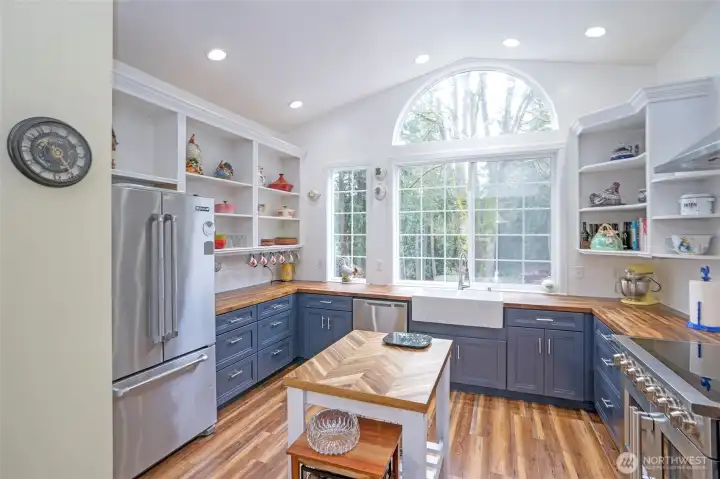 Featuring new cabinets, stainless steel appliances, and elegant butcher block counters.