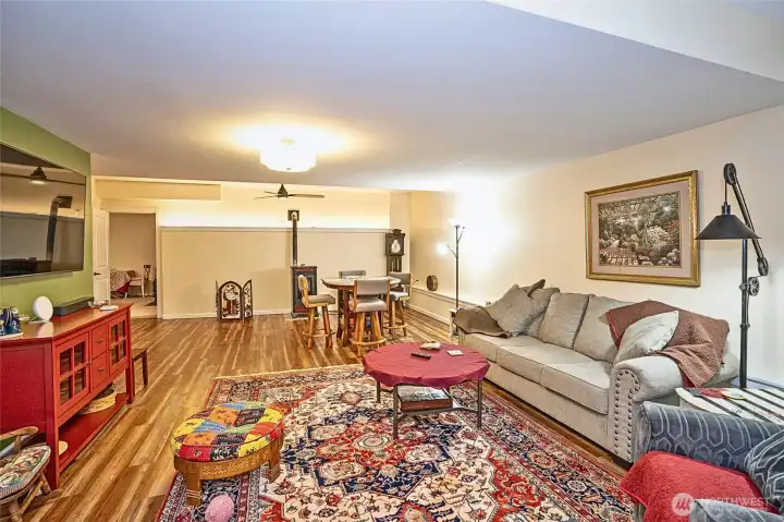 Generous family room featuring a cozy pellet stove and space for a game table.