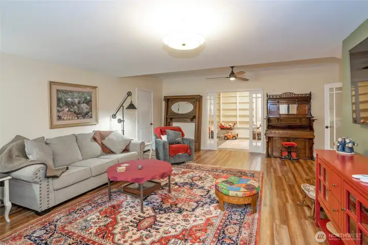 Another view of the family room looking into the extra finished room behind the glass pocket doors.