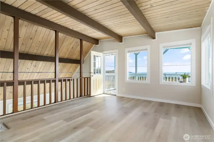 Large open loft easily held queen bed, set of double size bunk beds, 2 large dressers and love seat.  Door opens to upper view deck