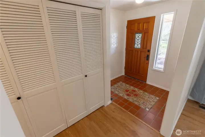 Front entry with beautiful tilework and large coat closet