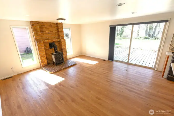 Family room with large slider to the backyard and cozy propane stove heater
