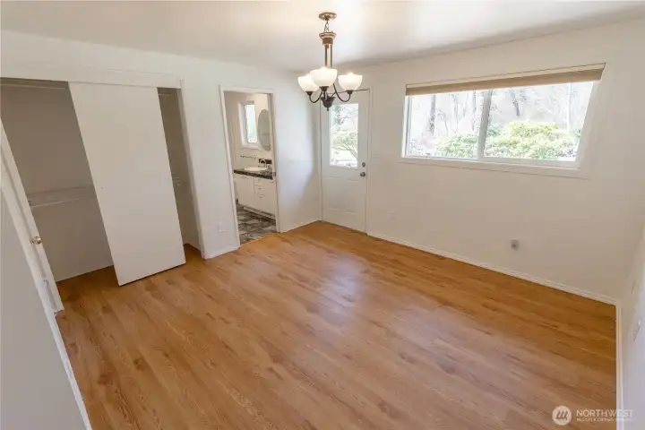 Primary bedroom with full en suite bathroom and door to the backyard