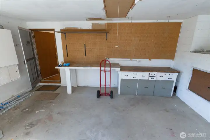 2-car garage with workbenches and storage