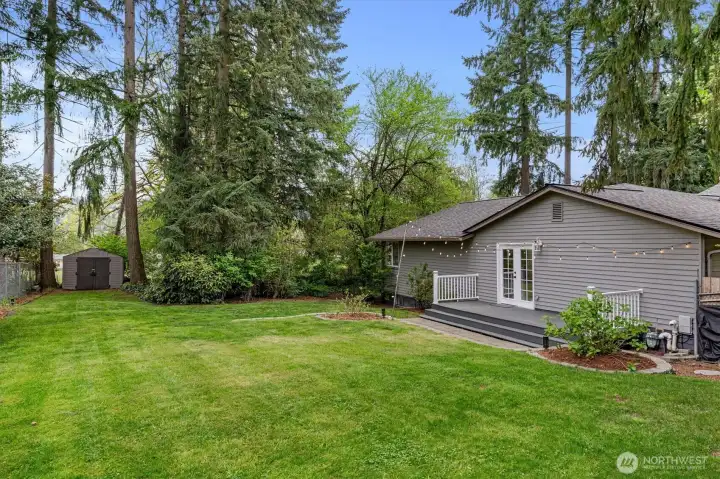 West side of the home with patio and level lawn - great for a game of touch football or badminton!