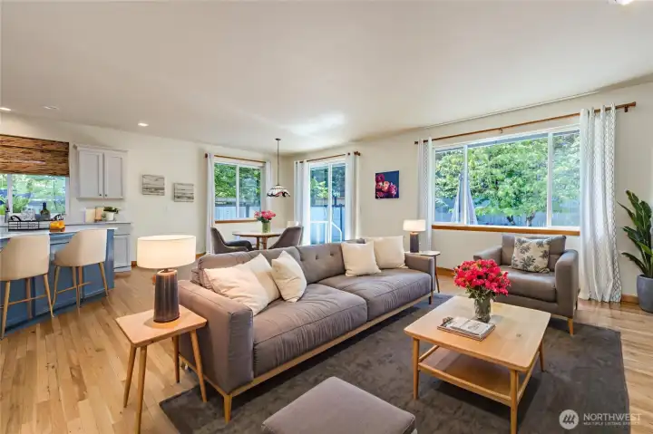 Open concept living area with gorgeous hardwood flooring. Virtually staged. Open concept living area with gorgeous hardwood flooring. Virtually staged.