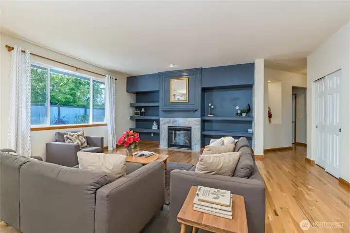 Living room features a gas fireplace and built-in shelving ready for your media setup. Virtually staged. Living room features a gas fireplace and built-in shelving ready for your media setup. Virtually staged.