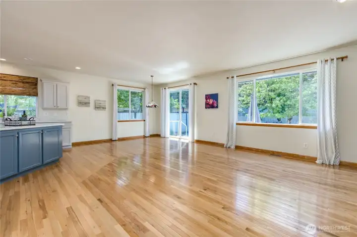 Open concept living area with gorgeous hardwood flooring.