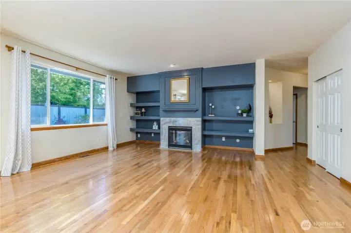 Living room features a gas fireplace and built-in shelving ready for your media setup.