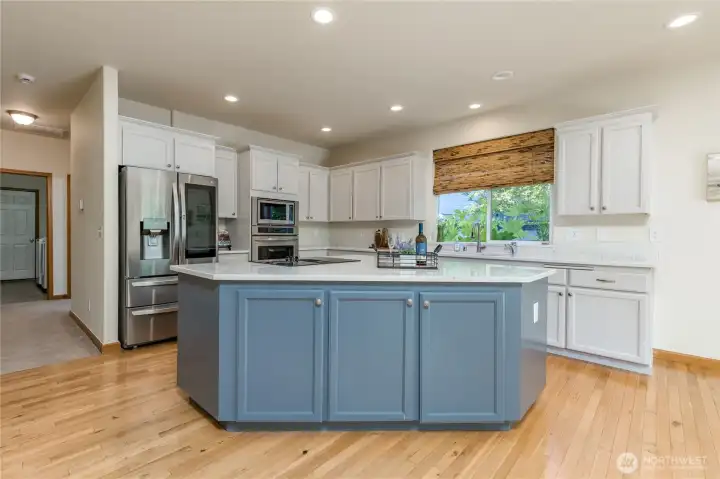 Stunning open kitchen with large quartz-topped island.