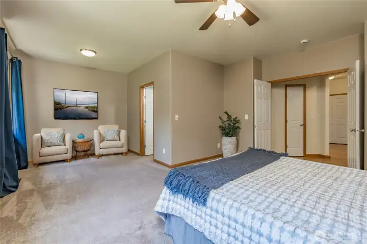 Double-door entry welcomes you into a vast primary bedroom with ample space for a cozy sitting area. Virtually staged. Double-door entry welcomes you into a vast primary bedroom with ample space for a cozy sitting area. Virtually staged.