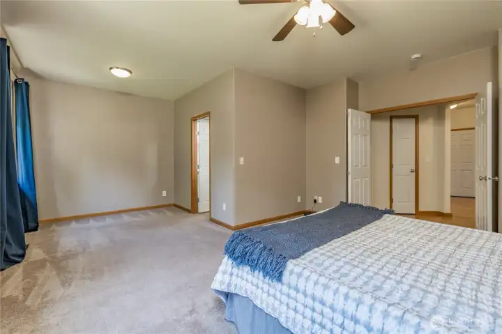 Double-door entry welcomes you into a vast primary bedroom with ample space for a cozy sitting area.