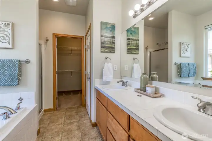 Bright 5-piece bathroom includes spacious walk-in closet and separate toilet room.