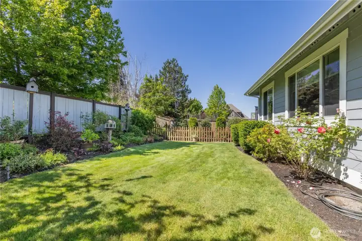 Serene and level backyard provides a peaceful outdoor oasis with plenty of room to relax or play.
