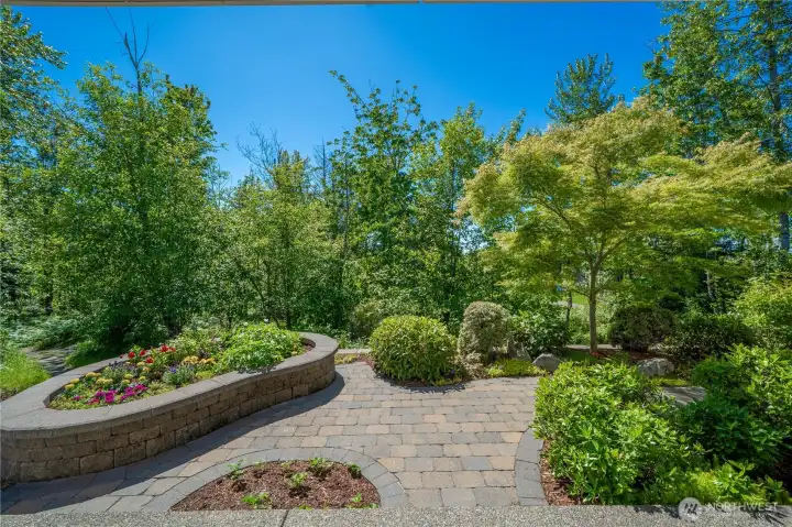 Perched on a permanent greenbelt, this home enjoys tranquil views. The thoughtfully designed hardscape, raised planter bed and beautiful plantings create a lovely yet low maintenance outdoor space.