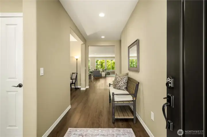 The generous entryway welcomes you with stunning luxury wide plank seamless flooring and views of the permanent greenbelt.