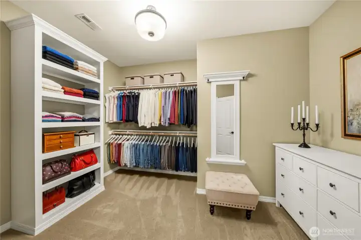 Primary closet with custom built-in storage.
