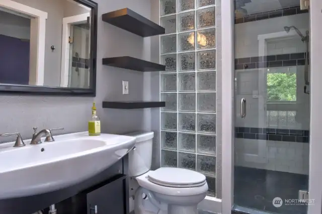 Floating shelves, glass block shower wall, modern styling