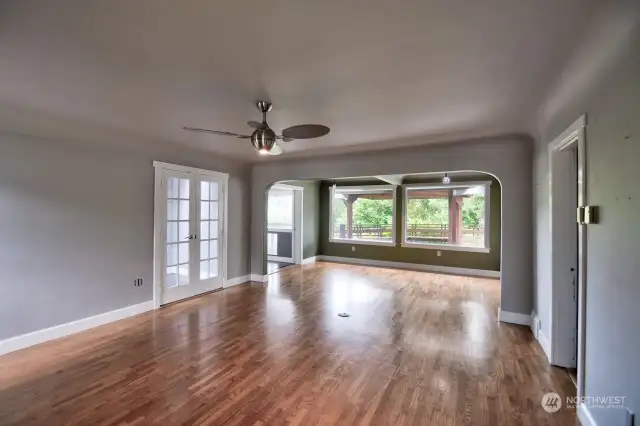 View from front door entrance - notice the lovely hardwood floors and coved ceilings. Dining room is located straight ahead in front of the windows.