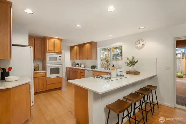 Refreshed kitchen with Cambria countertops and restained cabinets