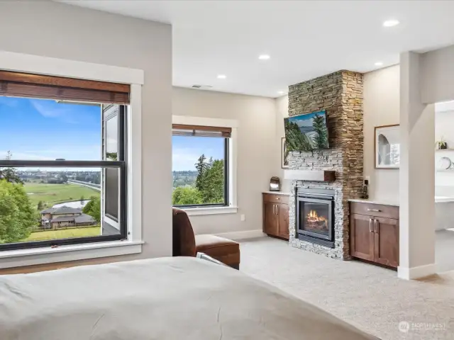 Primary bedroom with gas fireplace and beautiful views