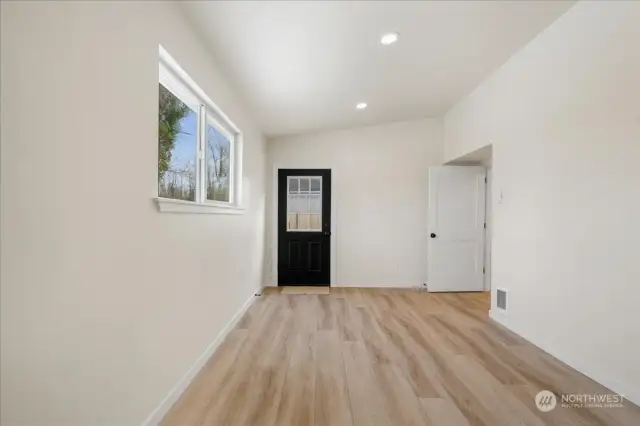 Extra large mudroom. Add some cabinets and coat hooks!