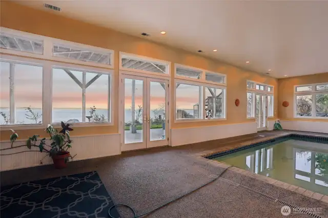 Swimming poool with views and living room amd fire place