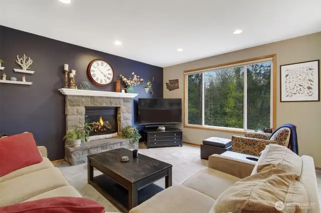 Family room with gas fireplace, large picture windows.